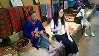 Snapshot with an old lady with facial and body tattoos in Binlang Ethnic Village, Sanya, Hainan Province